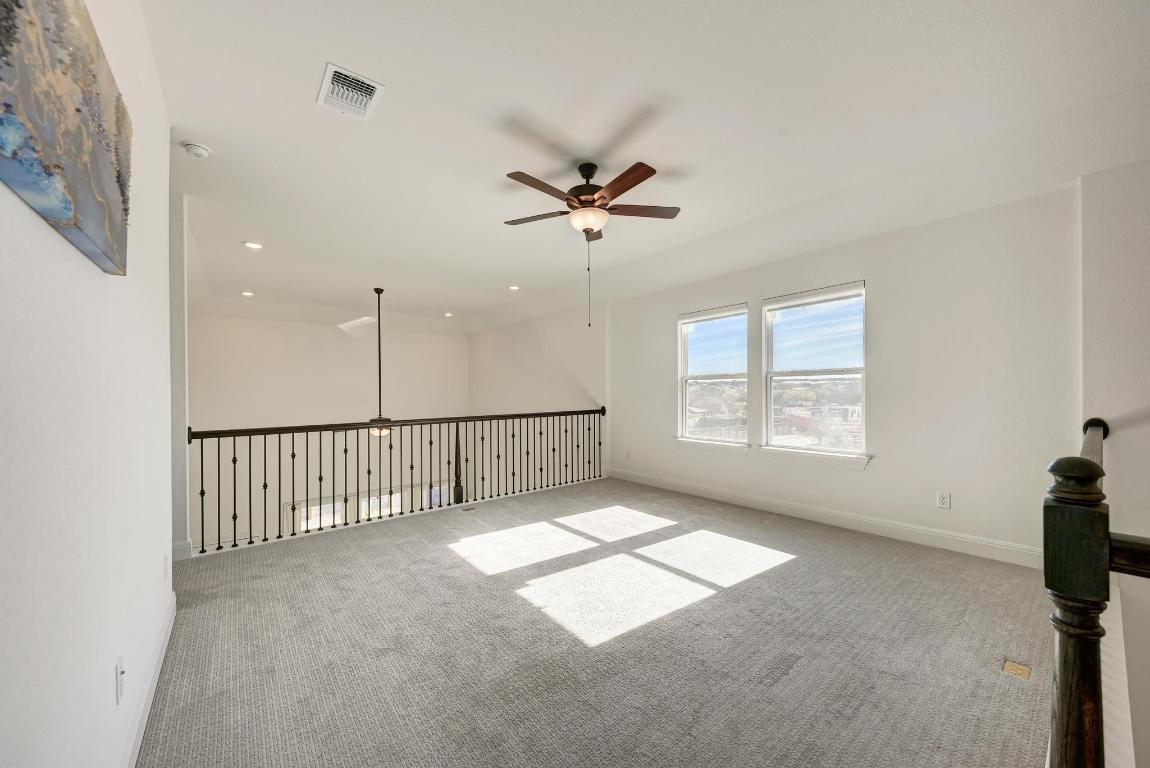 316 Regatta Trail Leander, TX 78641 - Photo 20 of 40 an empty room with windows and fan
