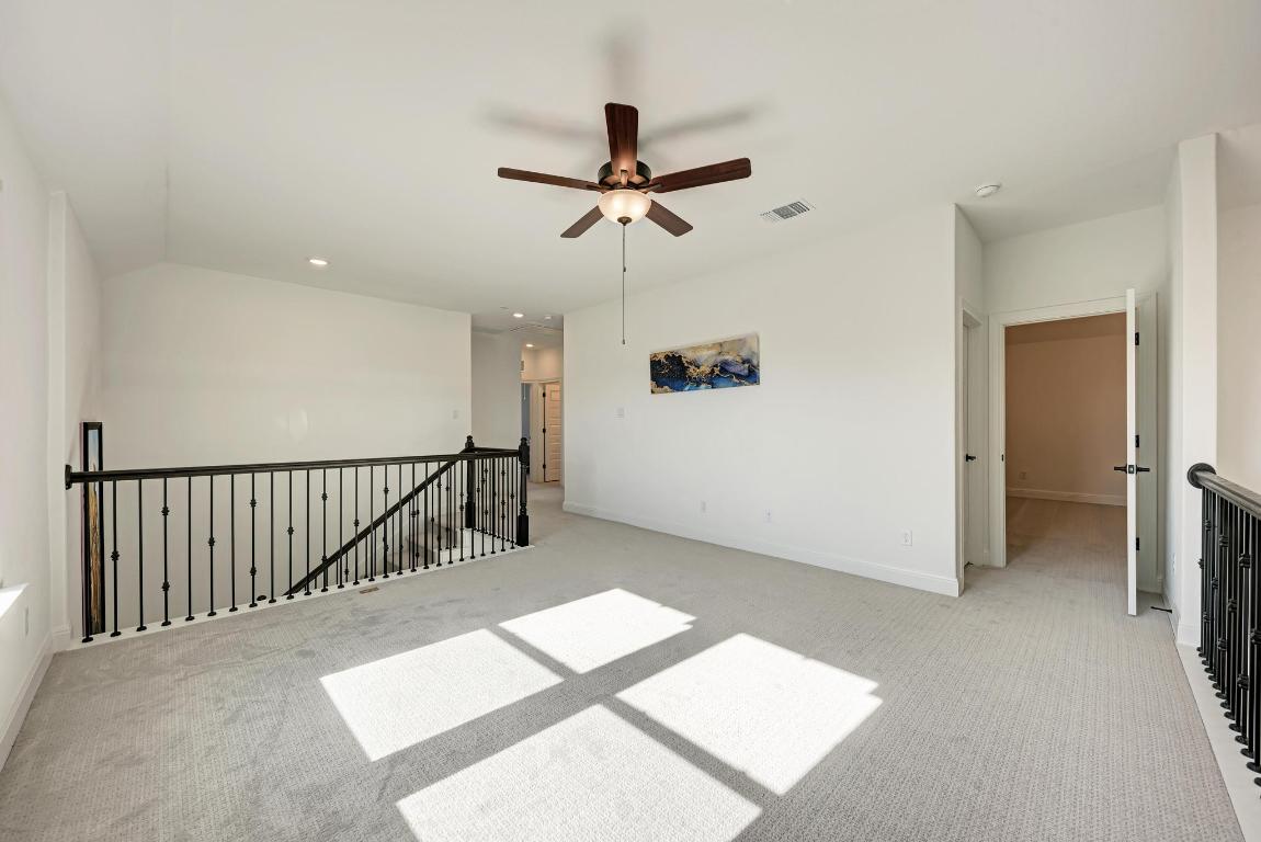 316 Regatta Trail Leander, TX 78641 - Photo 21 of 40 a view of a hallway with a chandelier fan