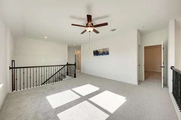 a view of a hallway with wooden floor and entryway
