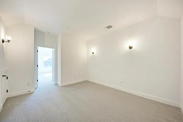 a view of a hallway with a chandelier fan and windows