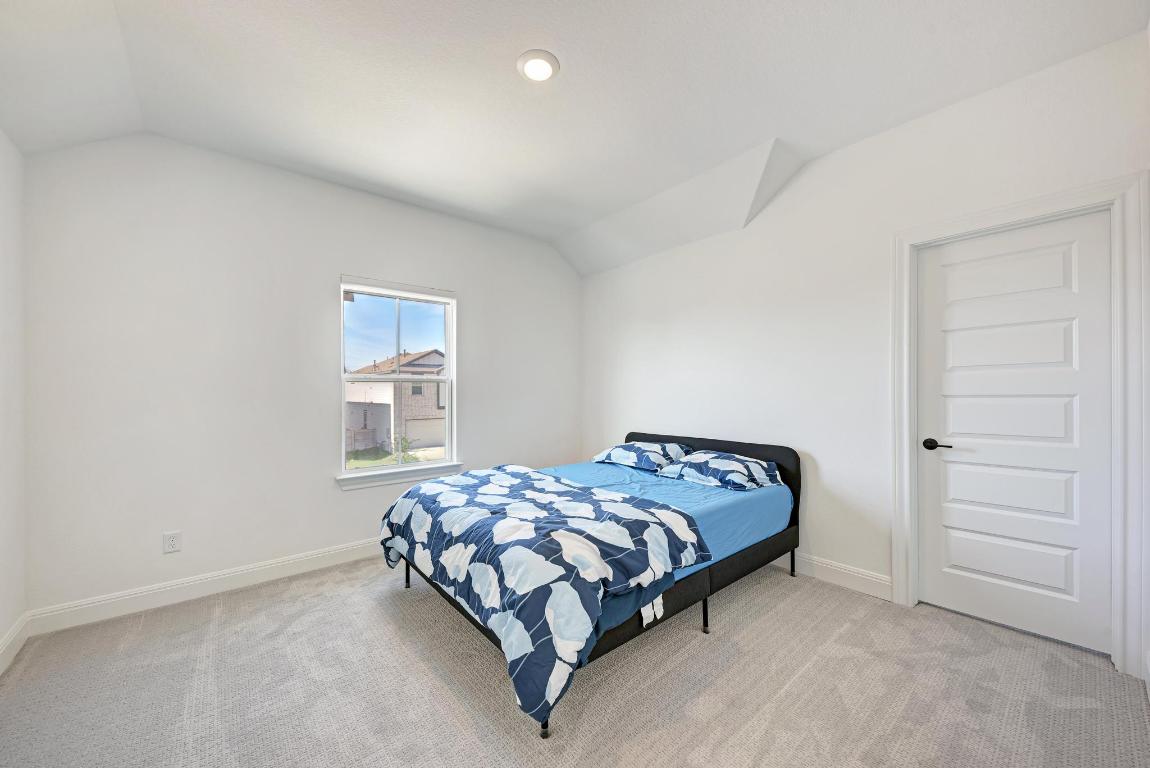 316 Regatta Trail Leander, TX 78641 - Photo 24 of 40 a bedroom with a bed and a window