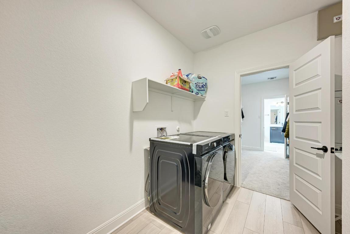316 Regatta Trail Leander, TX 78641 - Photo 31 of 40 a kitchen with a stove and white cabinets
