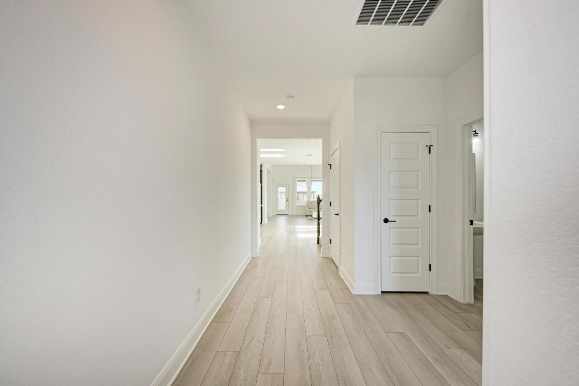 316 Regatta Trail Leander, TX 78641 - Photo 4 of 40 a view of a hallway with wooden floor