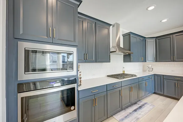 a kitchen with a refrigerator a sink and cabinets