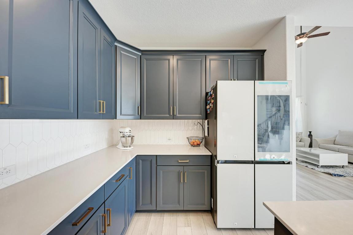 316 Regatta Trail Leander, TX 78641 - Photo 40 of 40 a kitchen with stainless steel appliances a refrigerator and a sink