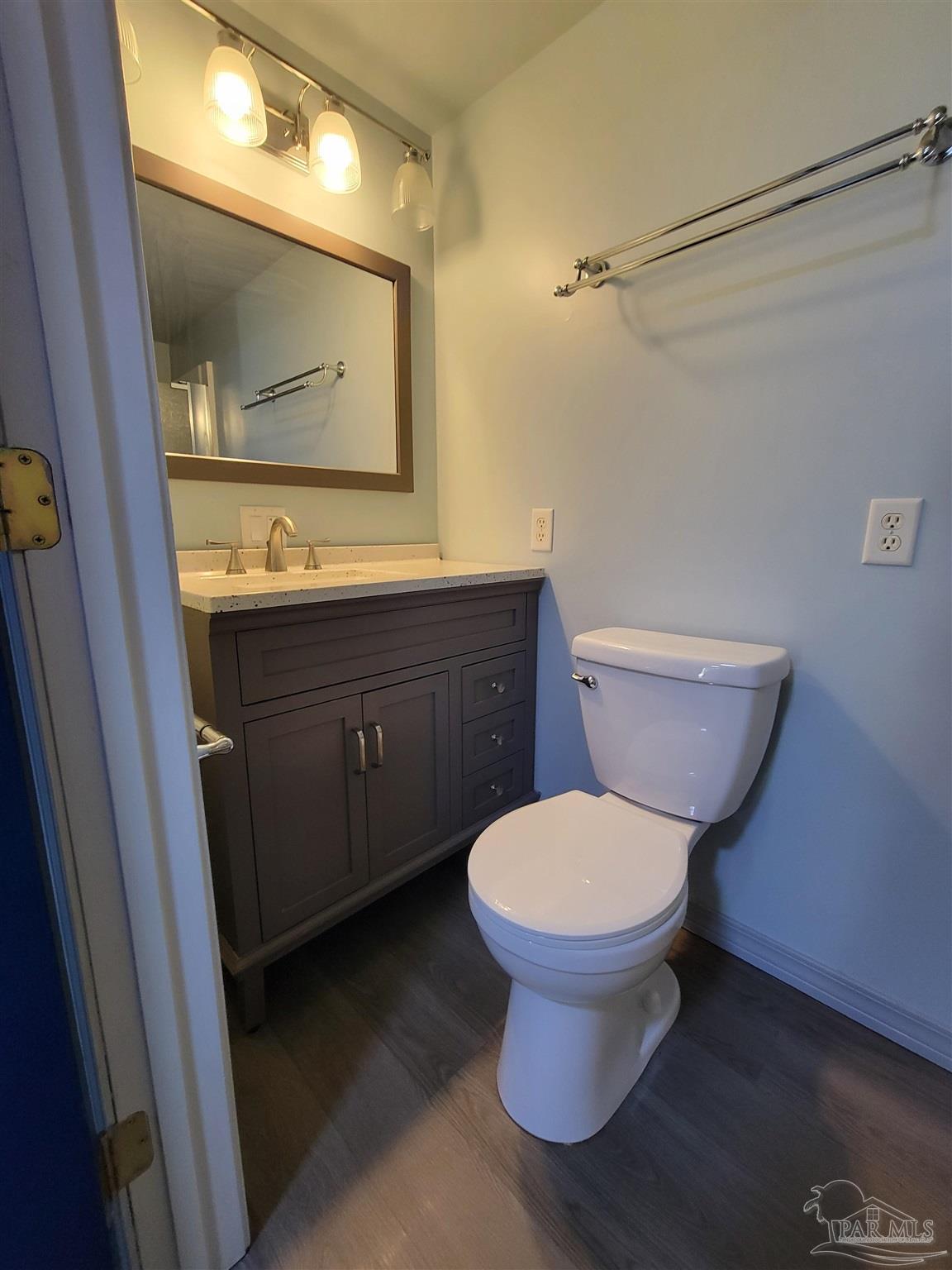 3217 Wallace Lake Road Pace, FL 32571 - Photo 13 of 17 a bathroom with a toilet sink and mirror