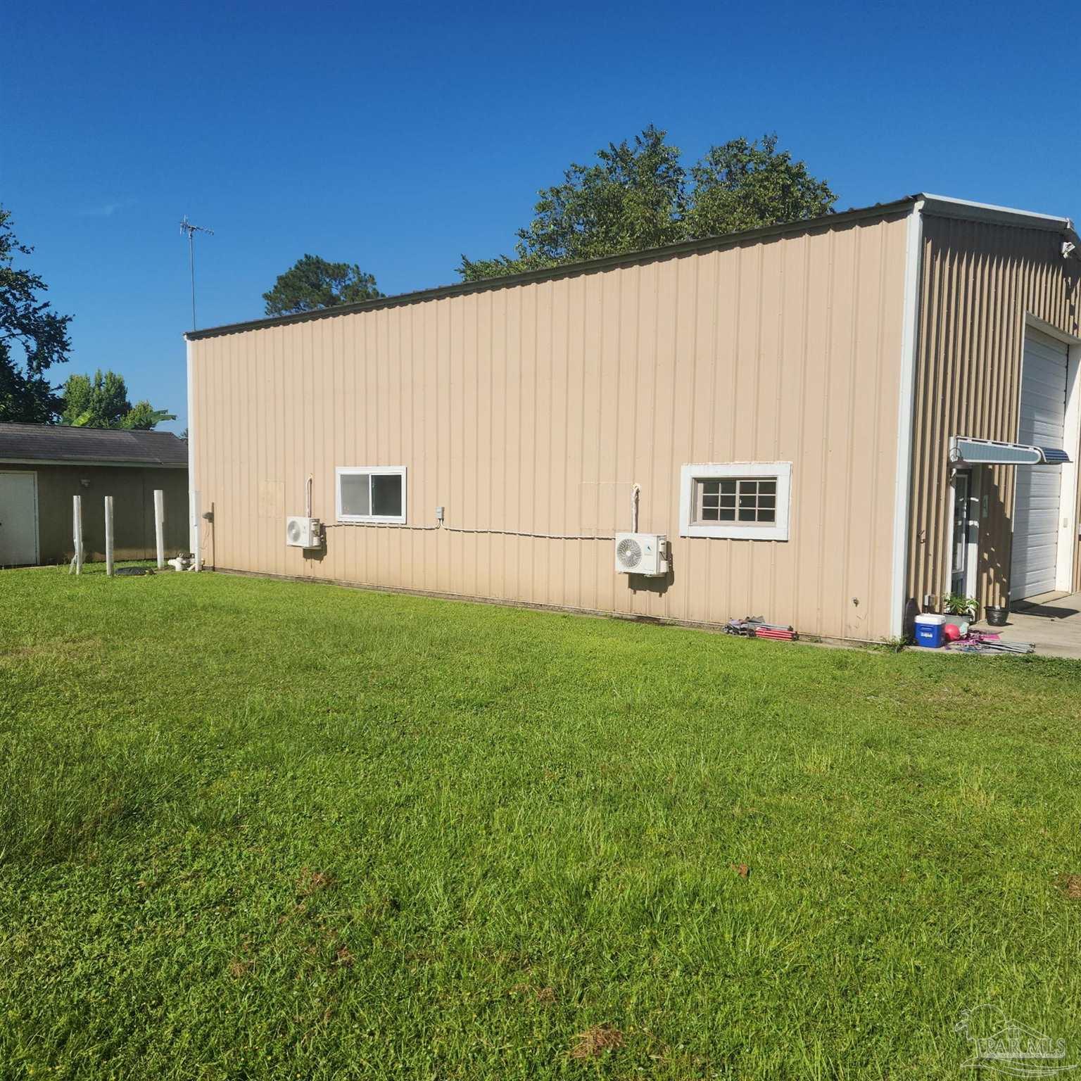 3217 Wallace Lake Road Pace, FL 32571 - Photo 3 of 17 a view of a backyard with plants and a garden
