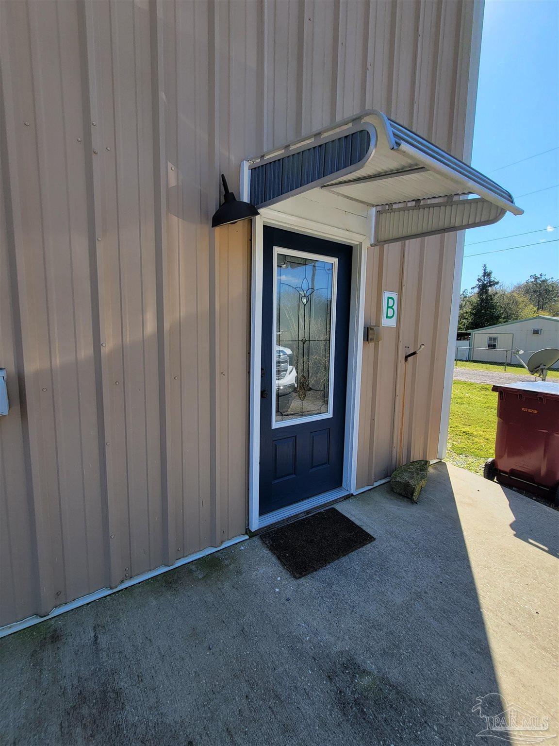 3217 Wallace Lake Road Pace, FL 32571 - Photo 5 of 17 a view of a door and wooden walls