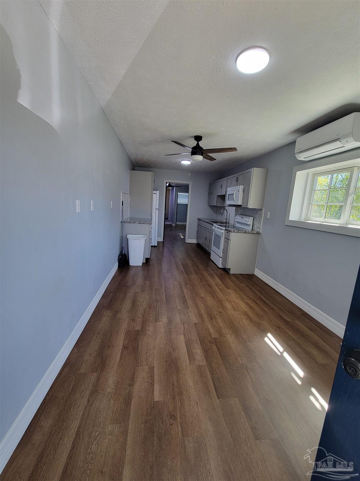 3217 Wallace Lake Road Pace, FL 32571 - Photo 7 of 17 a living room with furniture and a kitchen