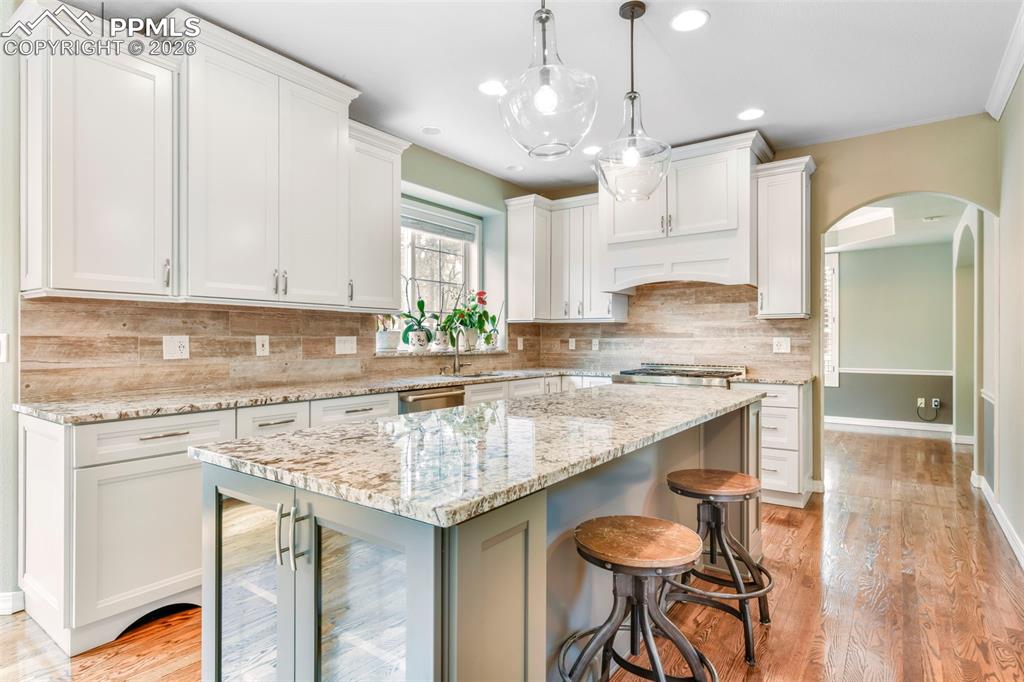 17725 Martingale Road Monument, CO 80132 - Photo 11 of 50 a kitchen with granite countertop a sink a center island and cabinets