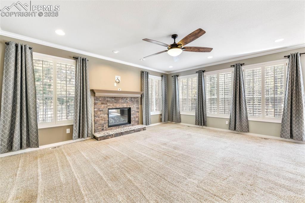 17725 Martingale Road Monument, CO 80132 - Photo 13 of 50 a view of an empty room with a fireplace and a window