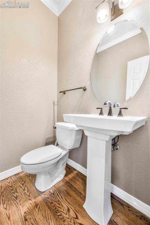 17725 Martingale Road Monument, CO 80132 - Photo 15 of 50 a bathroom with a sink toilet and a mirror