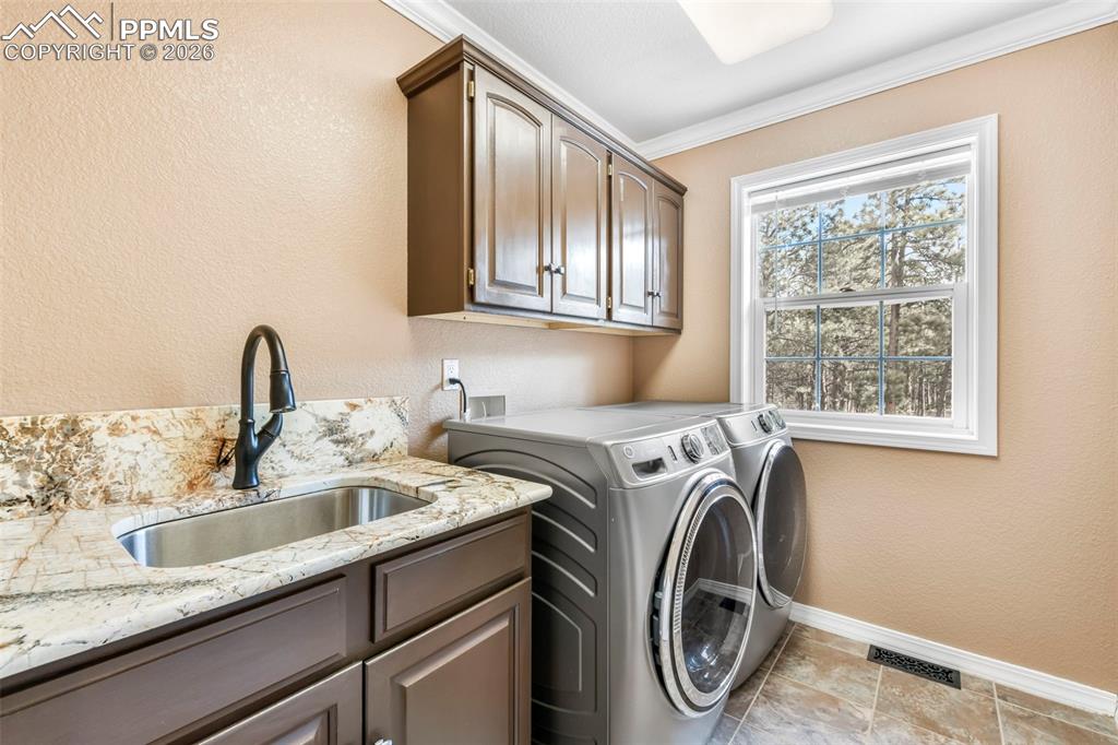 17725 Martingale Road Monument, CO 80132 - Photo 22 of 50 a utility room with sink dryer and washer