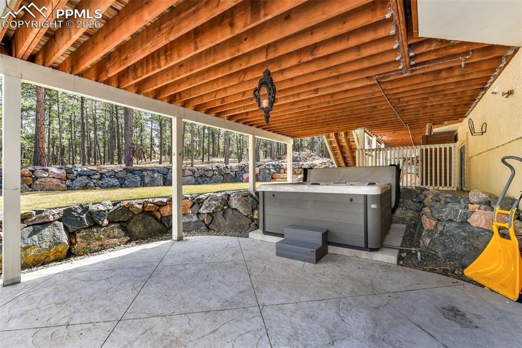 17725 Martingale Road Monument, CO 80132 - Photo 45 of 50 a view of a patio with a table and chairs and a barbeque