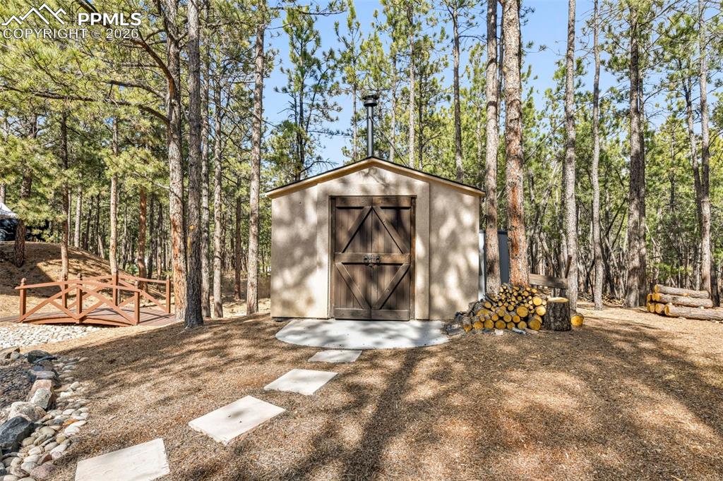 17725 Martingale Road Monument, CO 80132 - Photo 46 of 50 a view of a wooden house with large trees