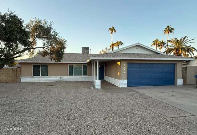 a view of a house with a yard and garage