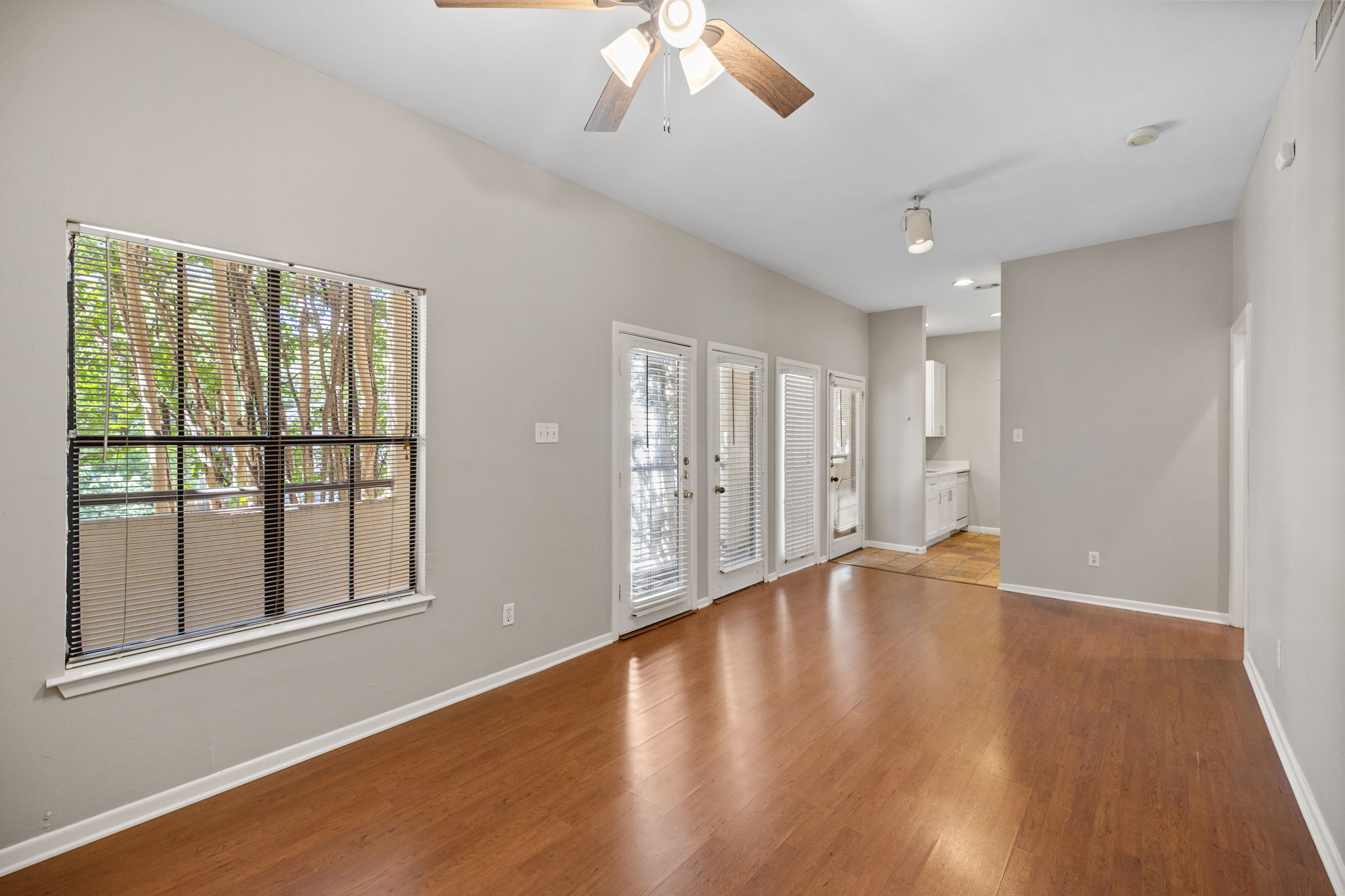 712 Graham Place, Unit 203 Austin, TX 78705 - Photo 26 of 30 a view of an empty room with wooden floor and a window