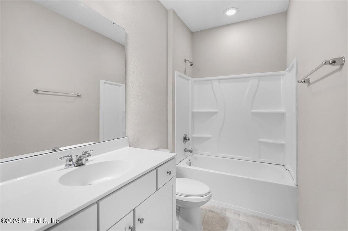 70 Stargaze Lane St. Augustine, FL 32095 - Photo 23 of 41 a bathroom with a sink toilet vanity and shower