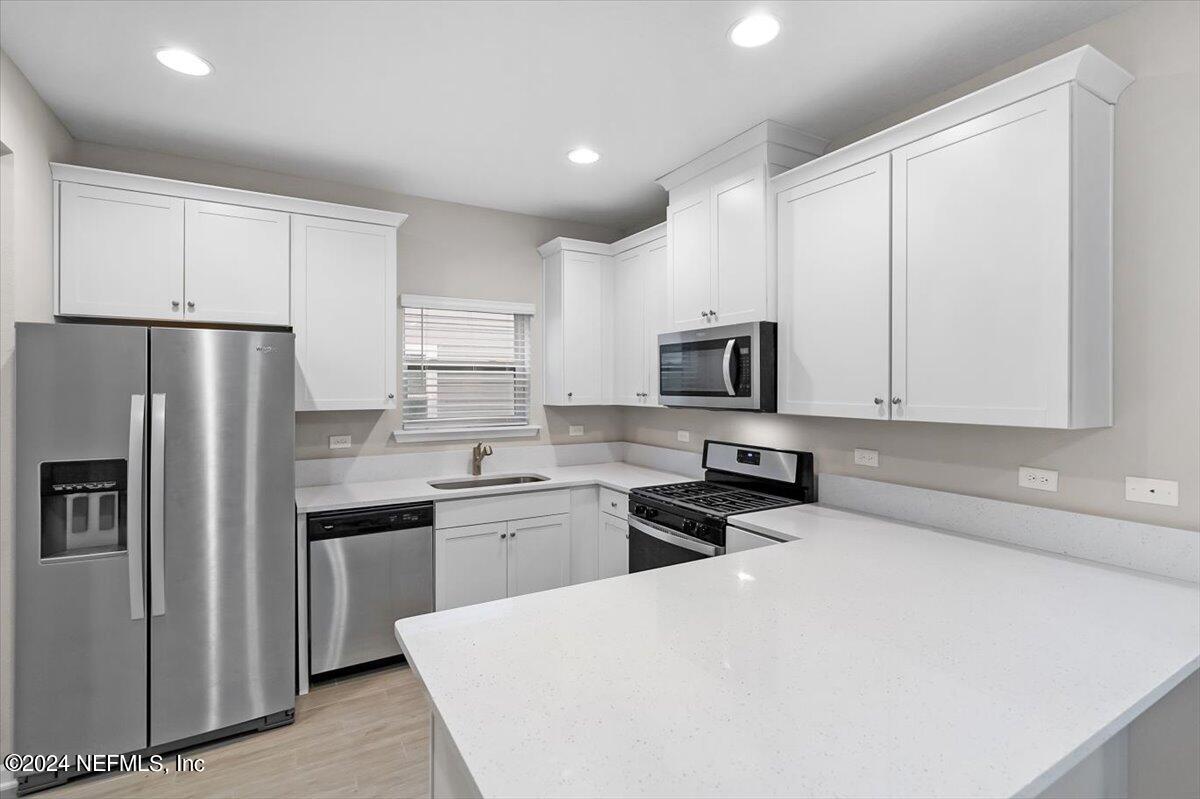 70 Stargaze Lane St. Augustine, FL 32095 - Photo 5 of 41 a kitchen with stainless steel appliances a refrigerator stove microwave and sink