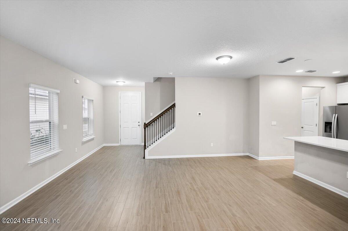 70 Stargaze Lane St. Augustine, FL 32095 - Photo 8 of 41 a view of an empty room with wooden floor and a window
