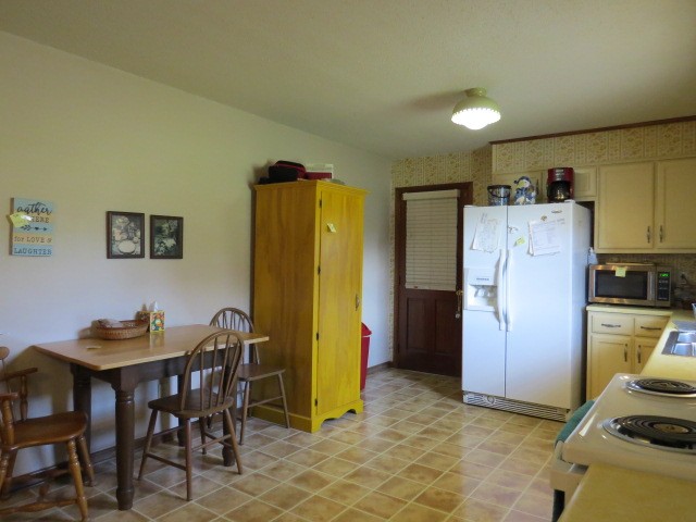1549 Mill Street Pulaski, TN 38478 - Photo 9 of 24 a kitchen with refrigerator and chairs