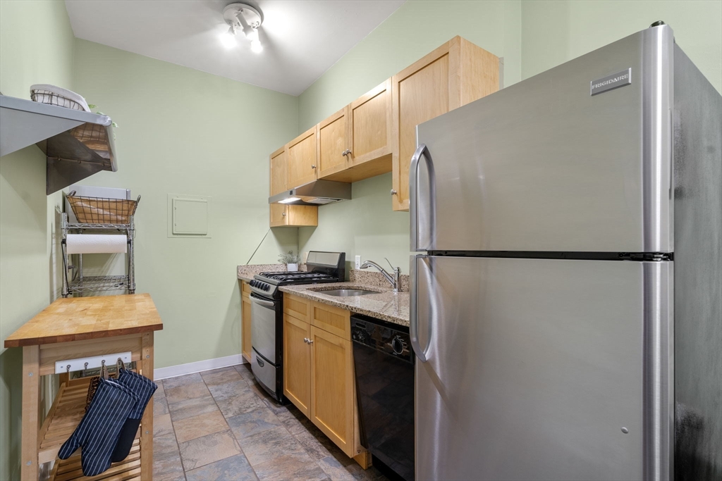 90 Kilsyth Road, Unit 2 Boston, MA 02135 - Photo 11 of 18 a kitchen with stainless steel appliances granite countertop a refrigerator a stove and a sink
