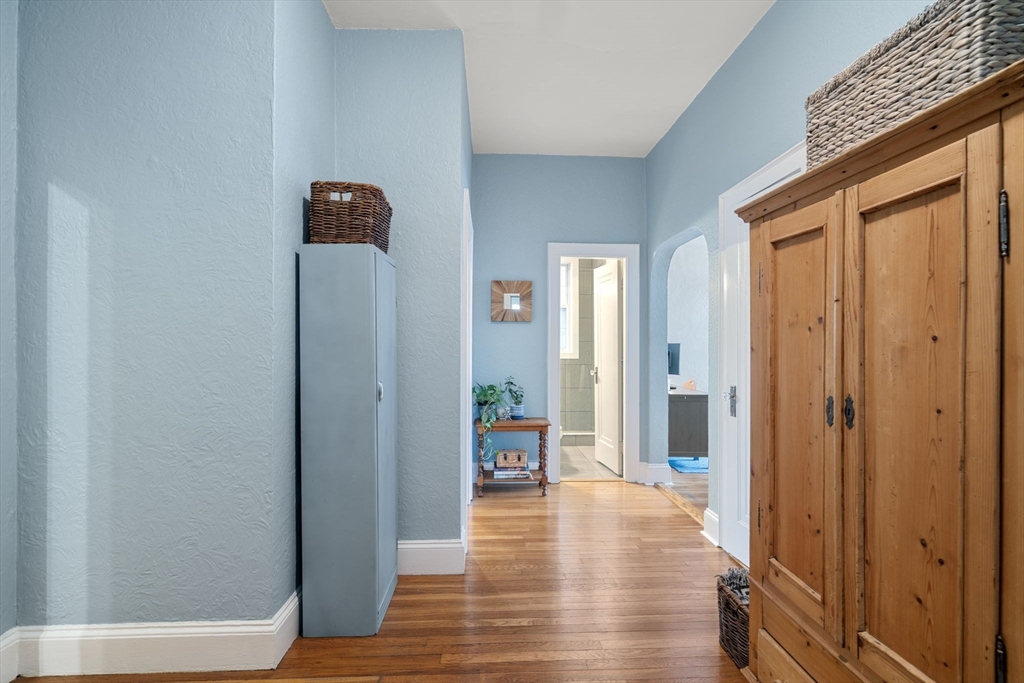 90 Kilsyth Road, Unit 2 Boston, MA 02135 - Photo 14 of 18 a view of a hallway with wooden floor and a living room