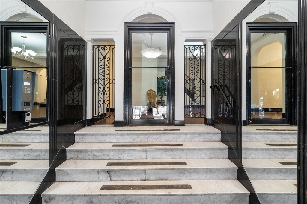 90 Kilsyth Road, Unit 2 Boston, MA 02135 - Photo 3 of 18 a view of a hallway with a fireplace and a mirror