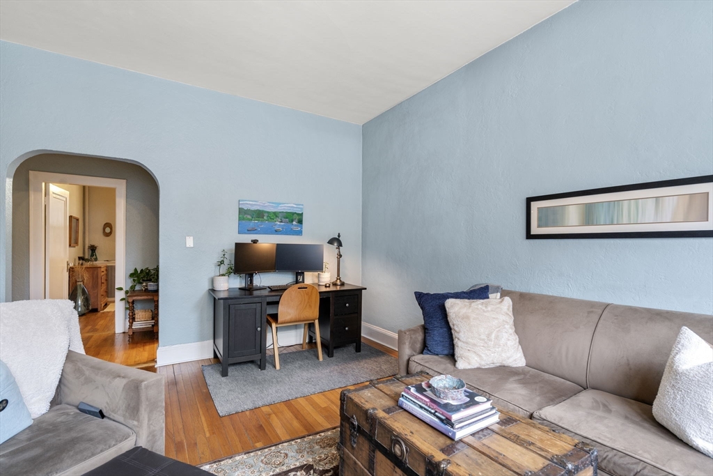 90 Kilsyth Road, Unit 2 Boston, MA 02135 - Photo 6 of 18 a living room with furniture and a dining table with wooden floor