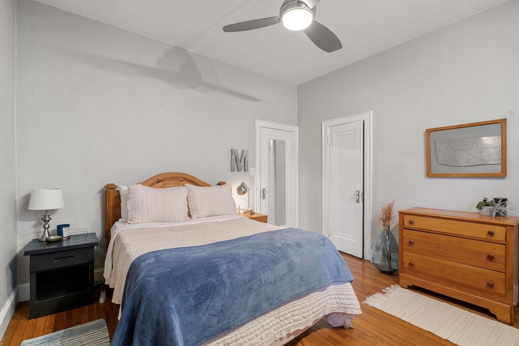 90 Kilsyth Road, Unit 2 Boston, MA 02135 - Photo 7 of 18 a bedroom with a bed and a chandelier
