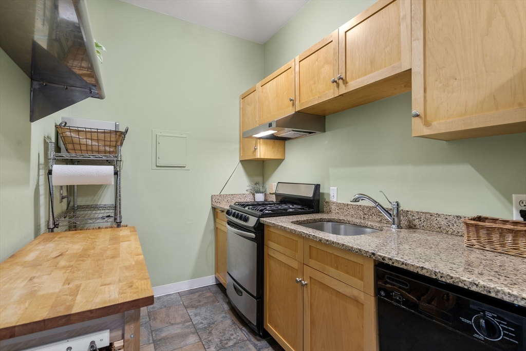 90 Kilsyth Road, Unit 2 Boston, MA 02135 - Photo 9 of 18 a kitchen with stainless steel appliances granite countertop a sink stove and cabinets