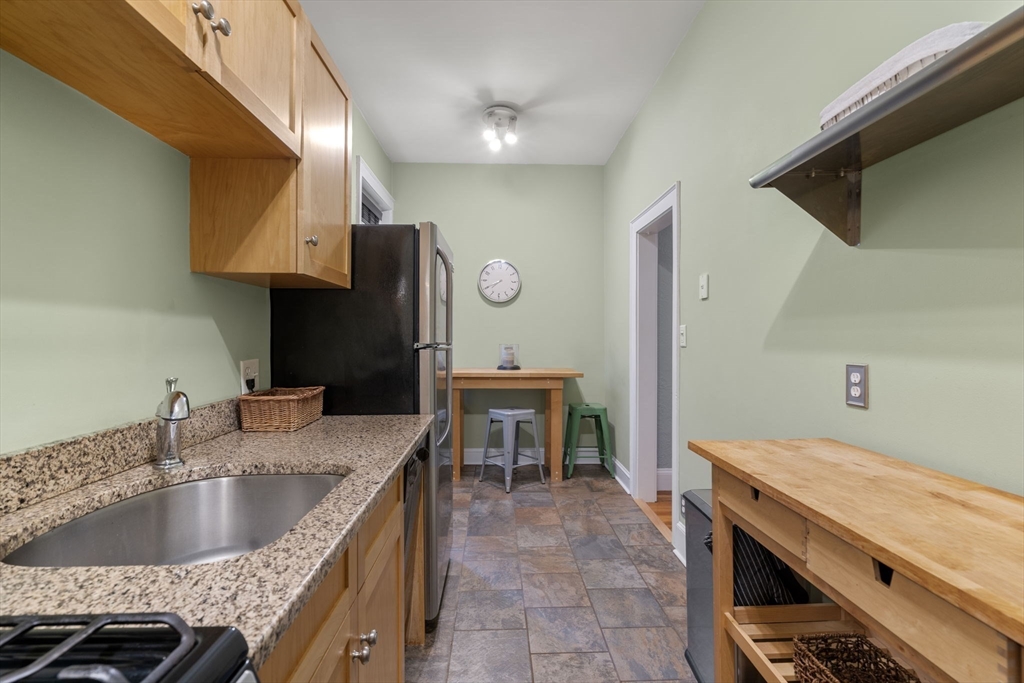 90 Kilsyth Road, Unit 2 Boston, MA 02135 - Photo 10 of 18 a kitchen with a sink and a refrigerator