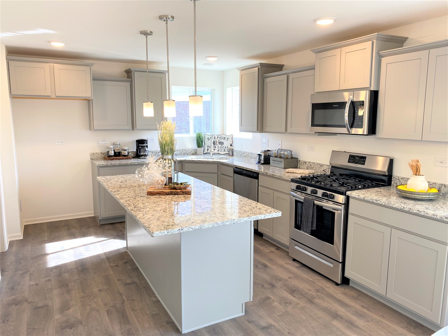 2035 Rownham Hill Road New Lenox, IL 60451 - Photo 5 of 15 a kitchen with stainless steel appliances kitchen island granite countertop a stove a sink a refrigerator and a microwave