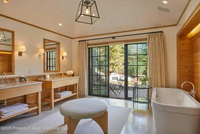 a bathroom with a tub sink toilet and mirror