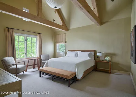 a bedroom with a bed a couch and dresser