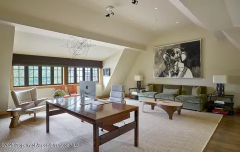 a living room with furniture a rug and a large window