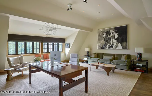 a living room with furniture a rug and a large window