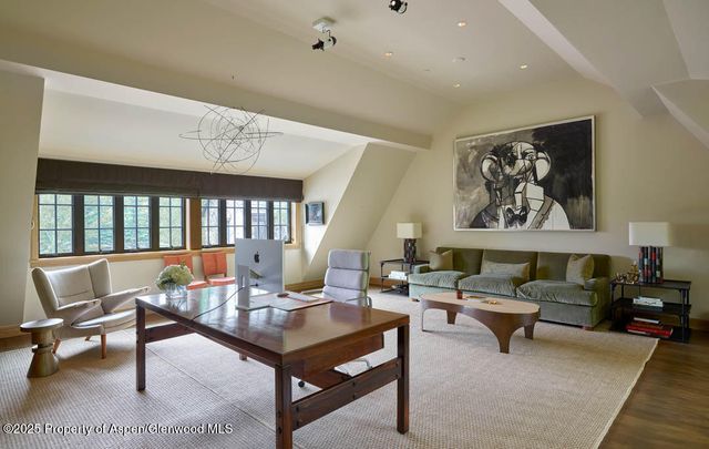 a living room with furniture a rug and a large window