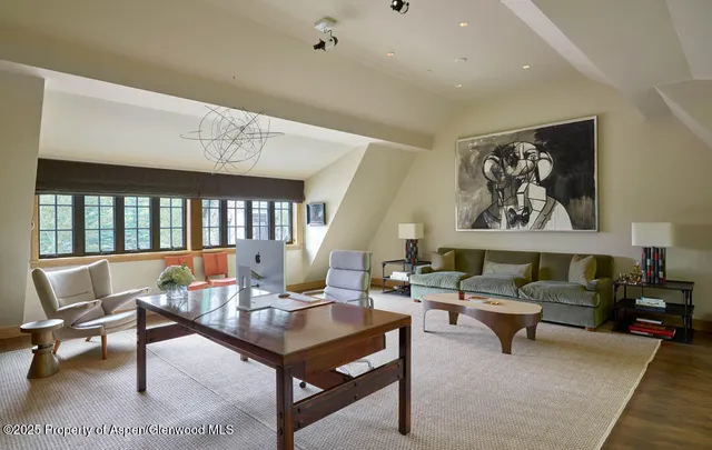 a living room with furniture a rug and a large window