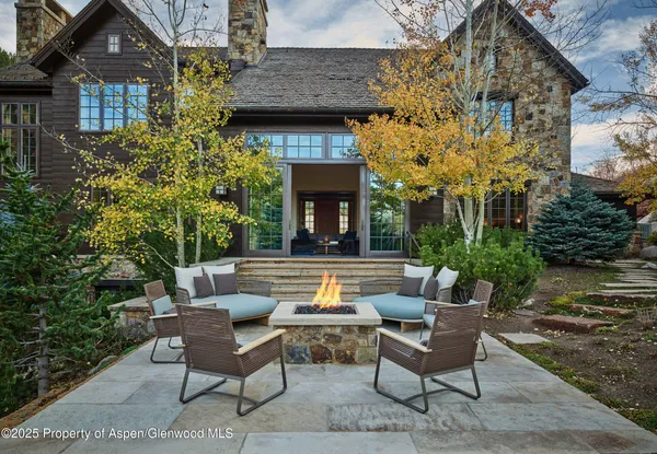a view of a house with a chairs and table in a patio