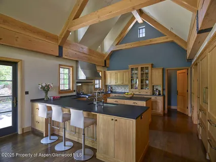 a kitchen with kitchen island granite countertop lots of counter top space and dining table
