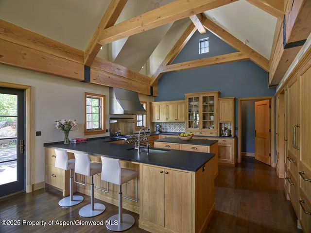a kitchen with kitchen island granite countertop lots of counter top space and dining table