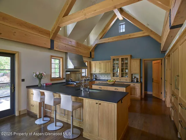 a kitchen with kitchen island granite countertop lots of counter top space and dining table