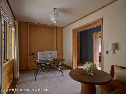 a workspace with furniture and a chandelier