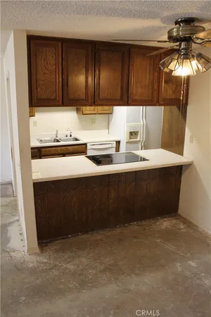 a kitchen with stainless steel appliances a sink stove and cabinets