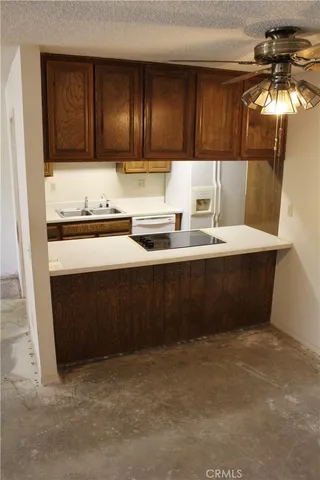 a kitchen with stainless steel appliances a sink stove and cabinets