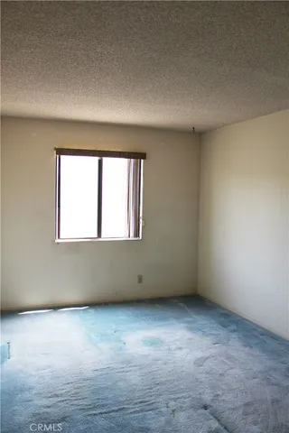 an empty room that has a large window