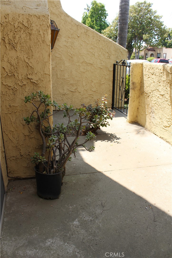 828 East Boone Street, Unit 12 Santa Maria, CA 93454 - Photo 2 of 32 a view of a backyard with plants and a bench