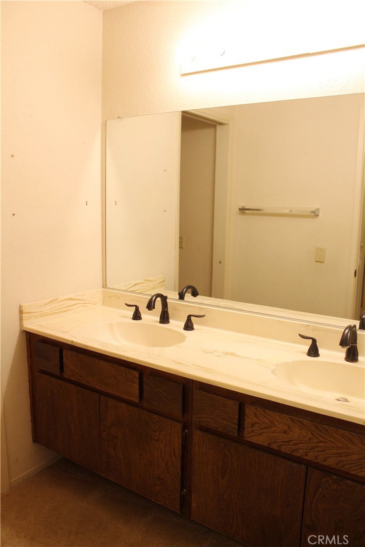 828 East Boone Street, Unit 12 Santa Maria, CA 93454 - Photo 22 of 32 a bathroom with a double vanity sink and a mirror