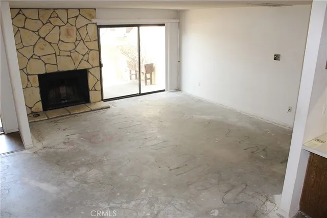 a view of empty room with a fireplace